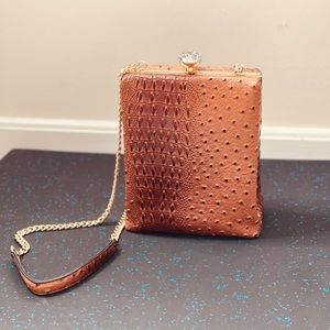 Brown animal skin vegan long string bag. Pearl knob opener.